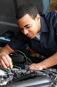 mechanic under hood 199x300 What Should I Fix on My Car Before Putting it Up for Sale?