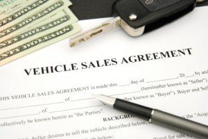 Vehicle Sales Agreement with car key and money and document